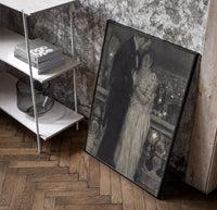 couple embracing on a night balcony vintage art print poster in a black frame leaning beside a shelf in a raw-plaster loft