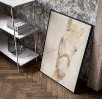 white horse head portrait with bridle vintage art print poster in a black frame leaning beside a shelf in a raw-plaster loft