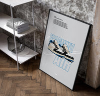 Travis Scott x Fragment Air Jordan 1 framed poster poster in a black frame leaning beside a shelf in a raw-plaster loft