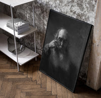 elderly bearded man in shadow vintage art print poster in a black frame leaning beside a shelf in a raw-plaster loft