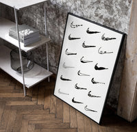 Nike Swoosh Hand-Drawn Sketch framed poster poster in a black frame leaning beside a shelf in a raw-plaster loft