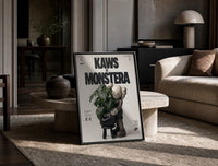 KAWS Companion Monstera Nike framed poster print in a black frame leaning on a travertine table in a sunlit lounge