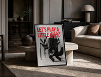 Let's Play a Little Game print on the floor, leaning against a travertine table