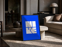 Nike Blue Typographic Logo print on the floor, leaning against a travertine table
