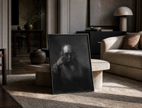 elderly bearded man in shadow vintage art print print in a black frame leaning on a travertine table in a sunlit lounge