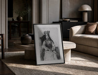 crowned queen seated portrait vintage art print print in a black frame leaning on a travertine table in a sunlit lounge