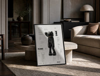 KAWS Companion Passing Through framed poster print in a black frame leaning on a travertine table in a sunlit lounge