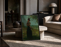 woman under a blossoming tree vintage art print print in a black frame leaning on a travertine table in a sunlit lounge