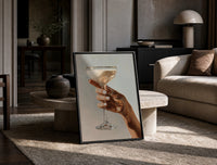 Cream Coupe in Hand print on the floor, leaning against a travertine table