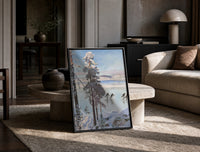 ice skaters on a frozen lake among snowy pines vintage art print print in a black frame leaning on a travertine table in…