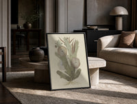 cactus with flowers vintage art print print in a black frame leaning on a travertine table in a sunlit lounge