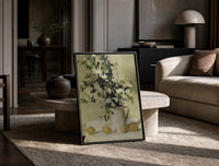 flowers and lemons still life vintage art print print in a black frame leaning on a travertine table in a sunlit lounge