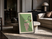 Just Do It Chameleon Green Pink print on the floor, leaning against a travertine table