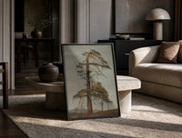 gnarled windblown pine tree against sky vintage art print print in a black frame leaning on a travertine table in a…