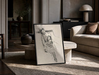 mother embracing seated daughter vintage art print print in a black frame leaning on a travertine table in a sunlit lounge