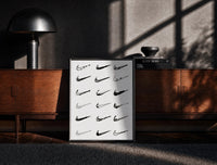 Black-framed Nike Swoosh Hand-Drawn Sketch framed poster print on a moody console with designer coffee-table books