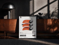 Black-framed SEAxFOOD Market Salmon Sushi Lighter print on the floor in front of a dark wooden console