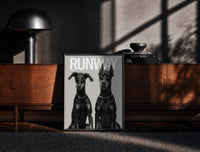 Black-framed Doberman Pinscher Portrait Duo print on the floor in front of a dark wooden console