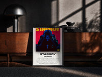 Black-framed The Weeknd Starboy Album Cover print on the floor in front of a dark wooden console