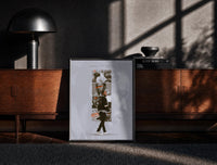 Black-framed Kendrick Lamar DAMN Collage print on the floor in front of a dark wooden console