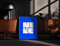 Black-framed Nike Blue Typographic Logo print on the floor in front of a dark wooden console