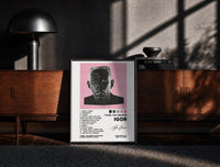 Black-framed Tyler, The Creator IGOR Tracklist print on the floor in front of a dark wooden console