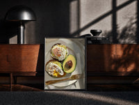 Black-framed Poached Eggs on Avocado Toast print on the floor in front of a dark wooden console