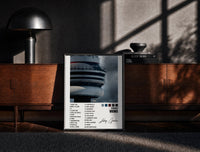 Black-framed Drake Views CN Tower Tracklist print on the floor in front of a dark wooden console