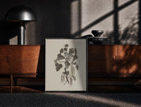 Black-framed engraved currant branch study vintage art print print on a moody console with designer coffee-table books