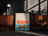 Black-framed Slow Day at Work Gone Fishing print on the floor in front of a dark wooden console