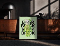 Black-framed Green Glow Skeleton Bearbrick print on the floor in front of a dark wooden console