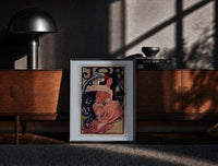 Black-framed Mucha JOB print on the floor in front of a dark wooden console
