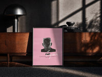 Black-framed Tyler the Creator IGOR print on the floor in front of a dark wooden console
