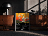 Black-framed Tyler the Creator Flower Boy Tracklist print on the floor in front of a dark wooden console