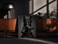 Black-framed Doberman Pistol Spiked Collar print on the floor in front of a dark wooden console