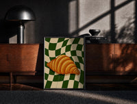 Black-framed Croissant on Green Checkerboard print on the floor in front of a dark wooden console