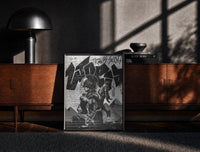 Black-framed Travis Scott Utopia Album Cover framed poster print on a moody console with designer coffee-table books