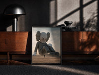 Black-framed KAWS Companion Desert Monochrome Streetwear print on the floor in front of a dark wooden console