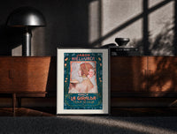 Black-framed Jabon Hiel de Vaca La Giralda print on the floor in front of a dark wooden console