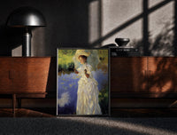 Black-framed woman with a parasol beside a lily pond vintage art print print on a moody console with designer…