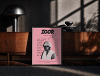 Black-framed Pink Tyler, the Creator IGOR Tracklist print on the floor in front of a dark wooden console