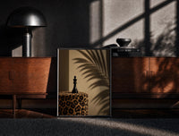 Black-framed Leopard Print Chess King print on the floor in front of a dark wooden console