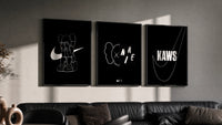 KAWS Companion XX Nike framed poster set of 3 triptych in three black frames on a grey wall above a leather sofa