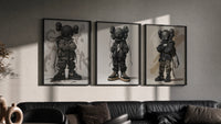 KAWS Nike Street triptych in three black frames on a grey wall above a leather sofa