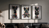 KAWS Companion Graffiti framed poster set of 3 triptych in three black frames on a grey wall above a leather sofa