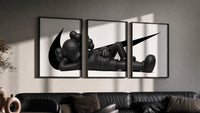 KAWS Companion triptych in three black frames on a grey wall above a leather sofa