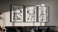 KAWS XX Crosshatch triptych in three black frames on a grey wall above a leather sofa