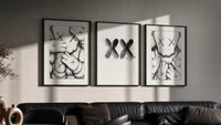 KAWS XX Outline Sketch triptych in three black frames on a grey wall above a leather sofa