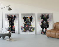 KAWS Companion Graffiti framed poster set of 3 three-panel set displayed beside a brown leather sofa