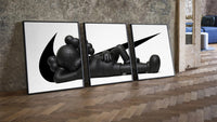 KAWS Companion three-piece set leaning on parquet beside a vintage loft door